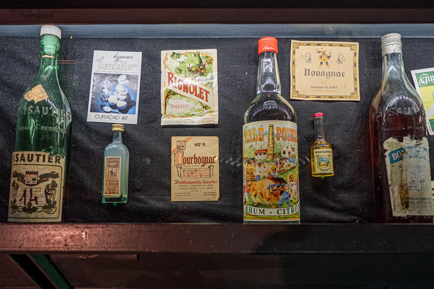 Ausgestellte alte Rumflaschen und Etiketten in einer Vitrine